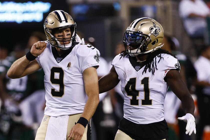 EAST RUTHERFORD, NJ - AUGUST 24: Drew Brees #9 and Alvin Kamara #41 of the New Orleans Saints celebrate a touchdown against the New York Jets during a pre-season game at MetLife Stadium on August 24, 2019 in East Rutherford, New Jersey. (Photo by Jeff Zelevansky/Getty Images)