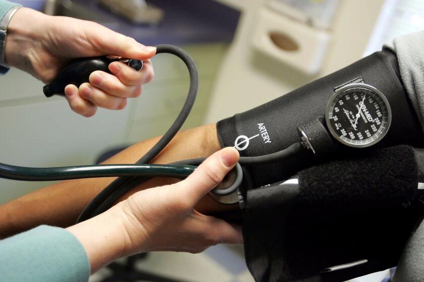 A doctor checks a patient's blood pressure. A new survey of primary care physicians finds widespread support for many of the Affordable Care Act's signature provisions.