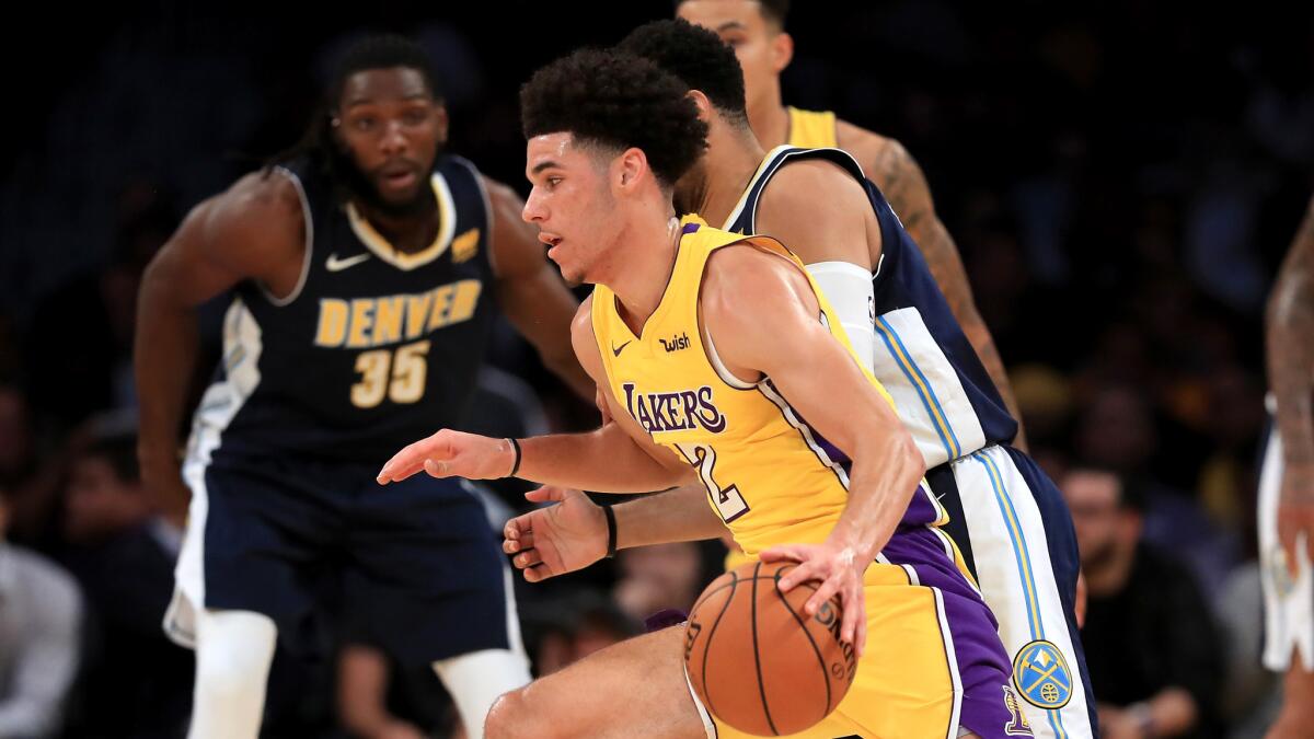Lakers point guard Lonzo Ball drives against the Nuggets during a preseason game Oct. 2.