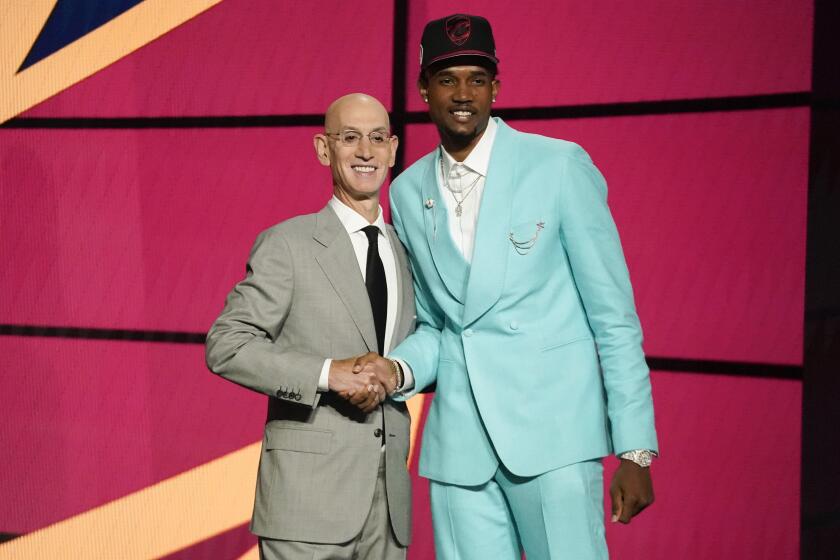Evan Mobley, right, poses for a photo with NBA Commissioner Adam Silver after being selected third overall by the Cleveland Cavaliers during the NBA basketball draft, Thursday, July 29, 2021, in New York. (AP Photo/Corey Sipkin)