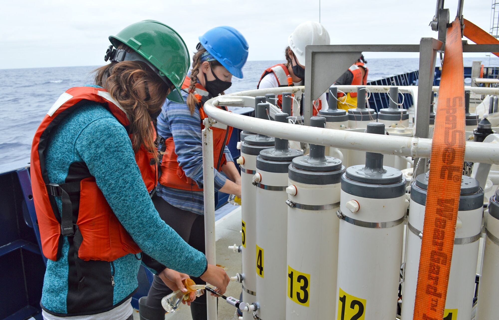 Members of the all women CalCOFI research team deploy equipment and working in labs.