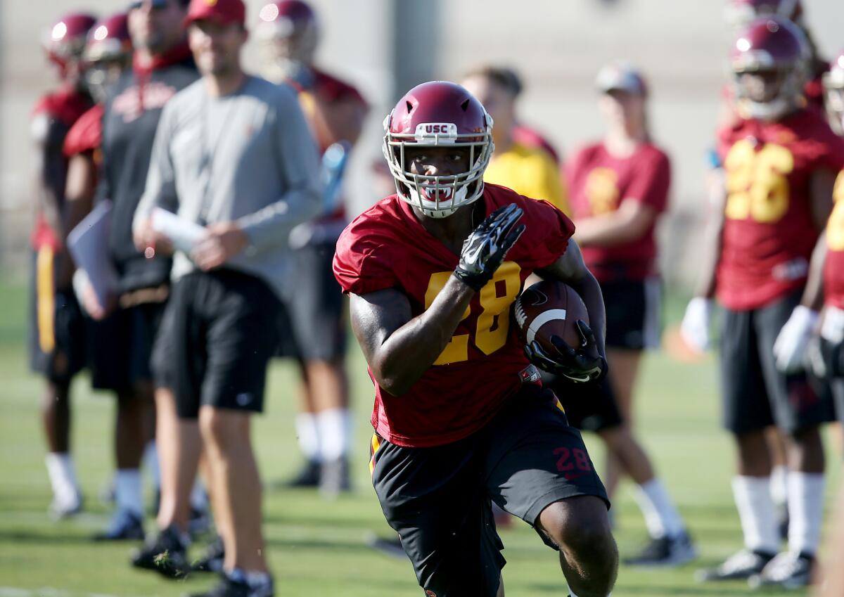 USC tailback Aca'Cedric Ware runs a play on the first day of fall training camp at Howard Jones Field on Aug. 4.