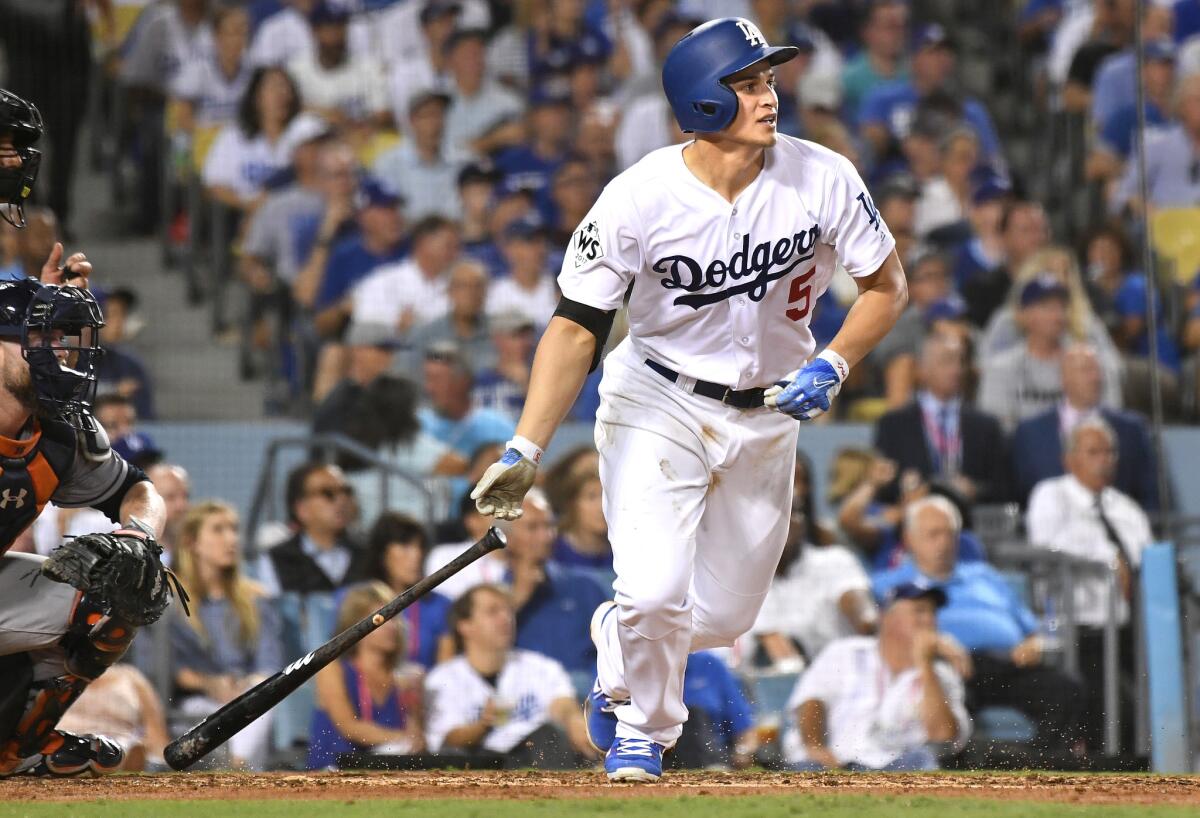 Corey Seager hits a single against the Astros in the fifth inning in Game 1 of the World Series.