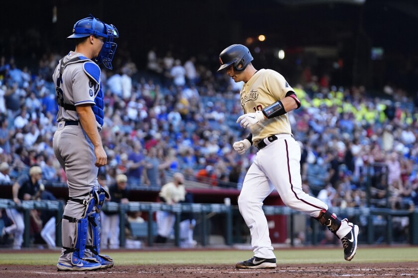 Arizona's Carson Kelly steps on home plate after hitting a solo home run in the second inning.