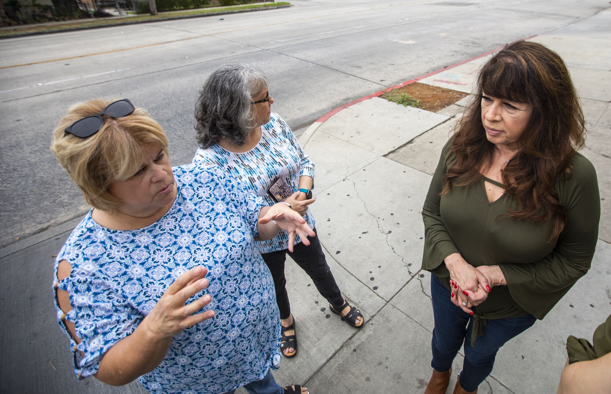 Three women stand near the area where their former classmate Jan Marsh used to frequent before her death at age 14.