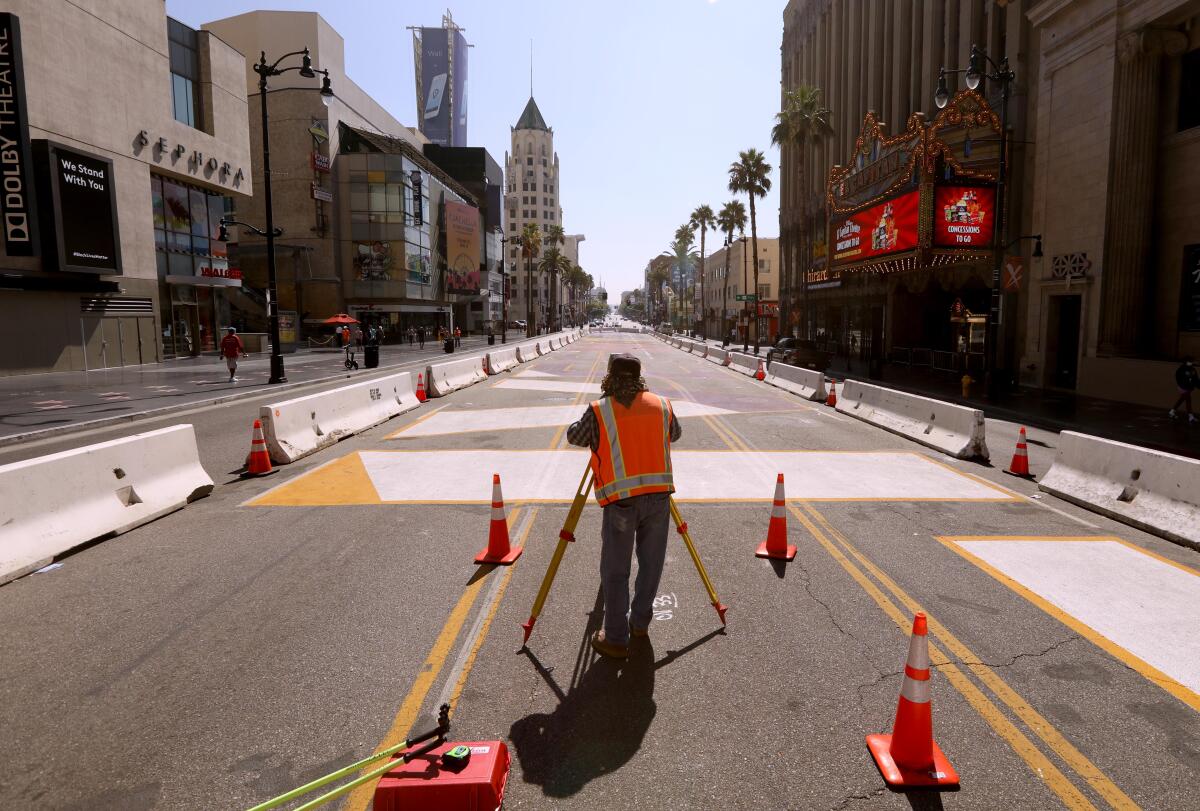 Jorge Martinez, with Calvada Survey Inc., surveys Hollywood Boulevard near the famed El Capitan and Dolby theaters.