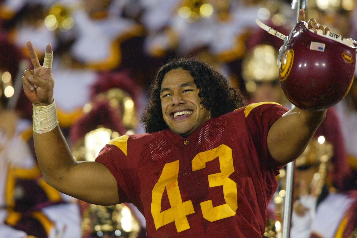 USC strong safety Troy Polamalu leads the team in a victory song after the Trojans defeated Notre Dame in 2002. Polamalu is among those named to the Polynesian Football Hall of Fame Class of 2016.