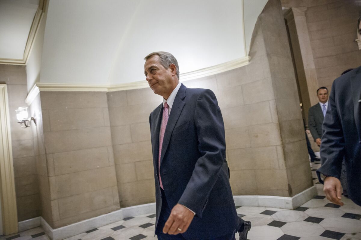 House Speaker John Boehner (R-Ohio) walks to the House chamber on Capitol Hill on Tuesday. The House passed a bill to fund the Department of Homeland Security without provisions rejecting President Obama's executive actions on immigration.