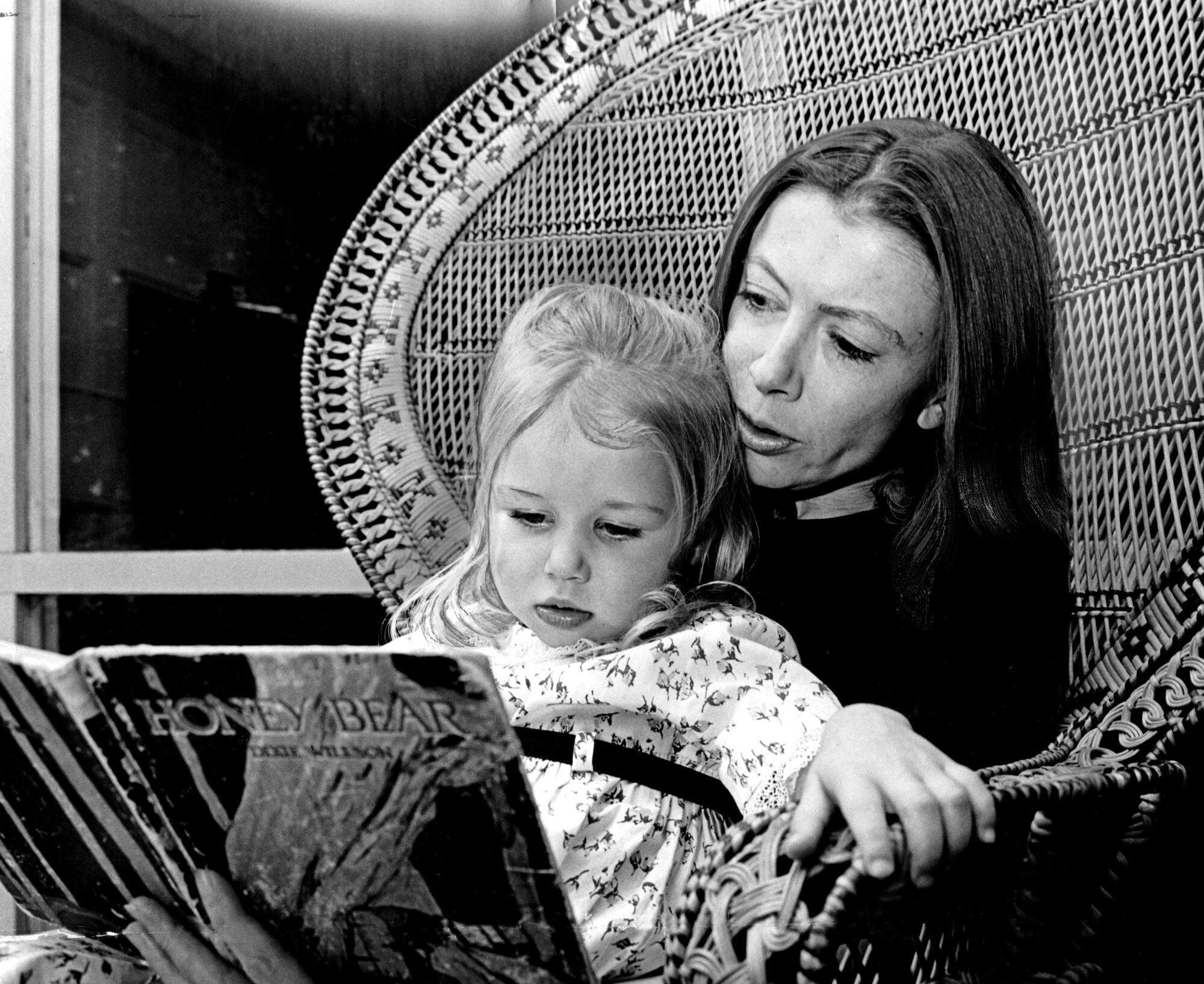 Joan Didion reads a book to her daughter, Quintana, as a child.