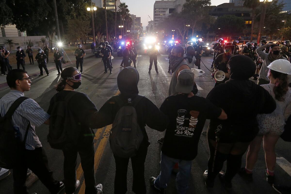 Protesters link arms during a demonstration Saturday in downtown Los Angeles.