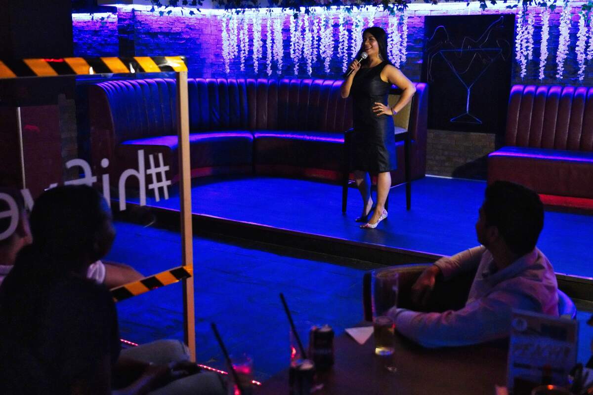 Filipina comedian Imah Dumagay performs stand-up comedy at an open-mic night at the Hi Five Restaurant & Lounge in Dubai, United Arab Emirates, Sunday, Aug. 8, 2021. Tucked within her slightly risqué set, Dumagay's rapid-fire punchlines offer an unfiltered glimpse into the life, sly triumphs and slights faced by her 2.2 million compatriots working in the Middle East. They send billions of U.S. dollars in remittances back to their families still living in the Philippines, but live in countries that often treat them as a disposable, low-paid workforce. (AP Photo/Jon Gambrell)