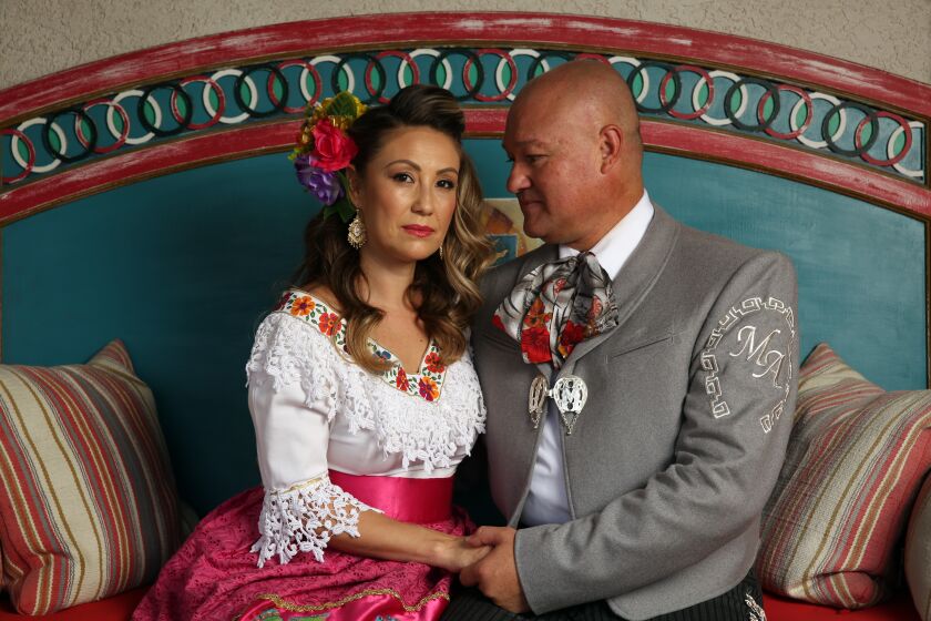 LOS ANGELES, CA - APRIL 26: Susie Garcia and Pepe Martinez Jr. pose for a portrait in Rowland Heights on Sunday, April 26, 2020 in Los Angeles, CA. Garcia is part of the all-female mariachi band Las Colibri and Martinez Jr. is also a renowned mariachi. (Dania Maxwell / Los Angeles Times)