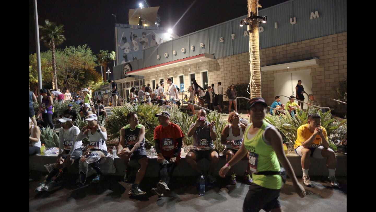 Runners wait for the start of the 30th Los Angeles Marathon at Dodger Stadium on Sunday morning.