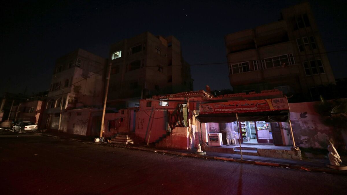 A small shop is seen between houses of Palestinian refugees during a power outage at al Shateaa refugee camp in Gaza City on July 30.