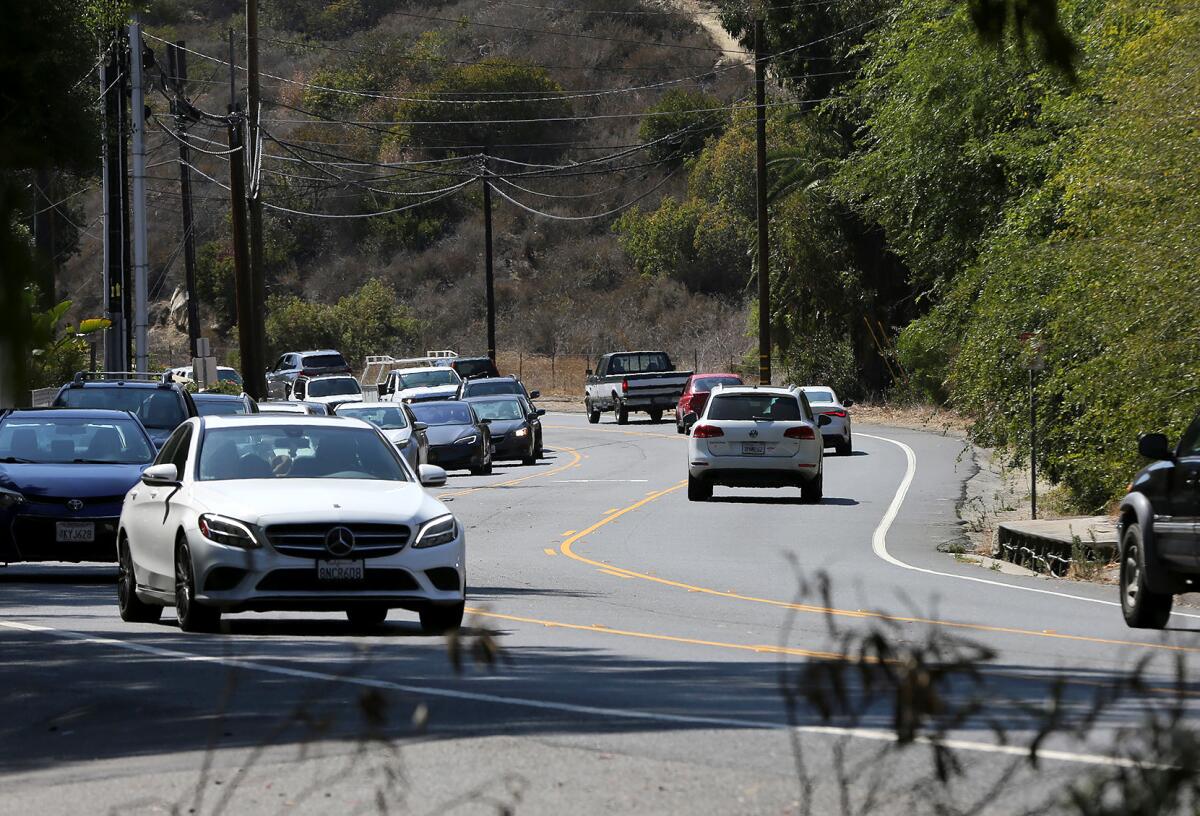 A look at traffic rolling along Laguna Canyon Road in Laguna Beach on Aug. 9, 2021.