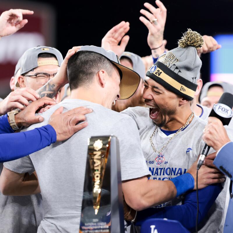 Dodgers shortstop Tommy Edman, left, celebrates with Mookie Betts after being named MVP of the NLCS.