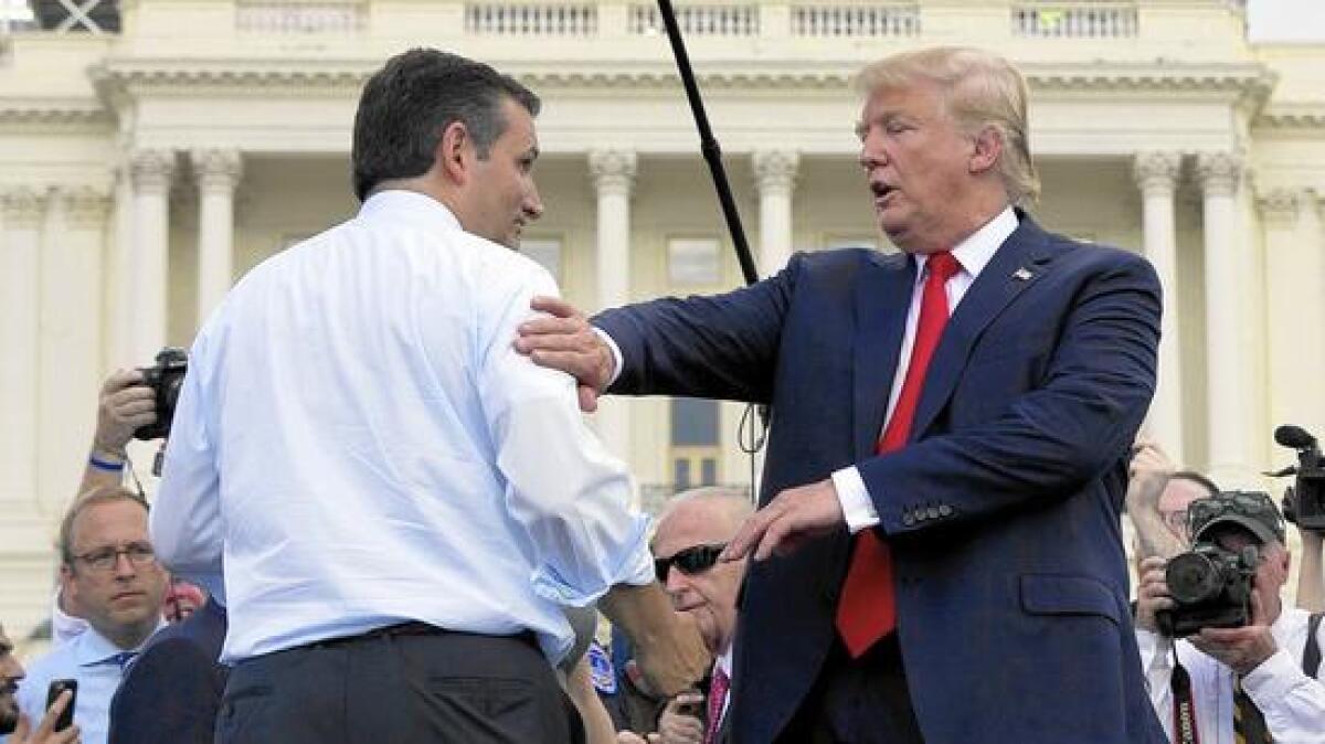 Republican presidential candidates Ted Cruz, left, and Donald Trump meet onstage during a rally outside the Capitol last spring in Washington.