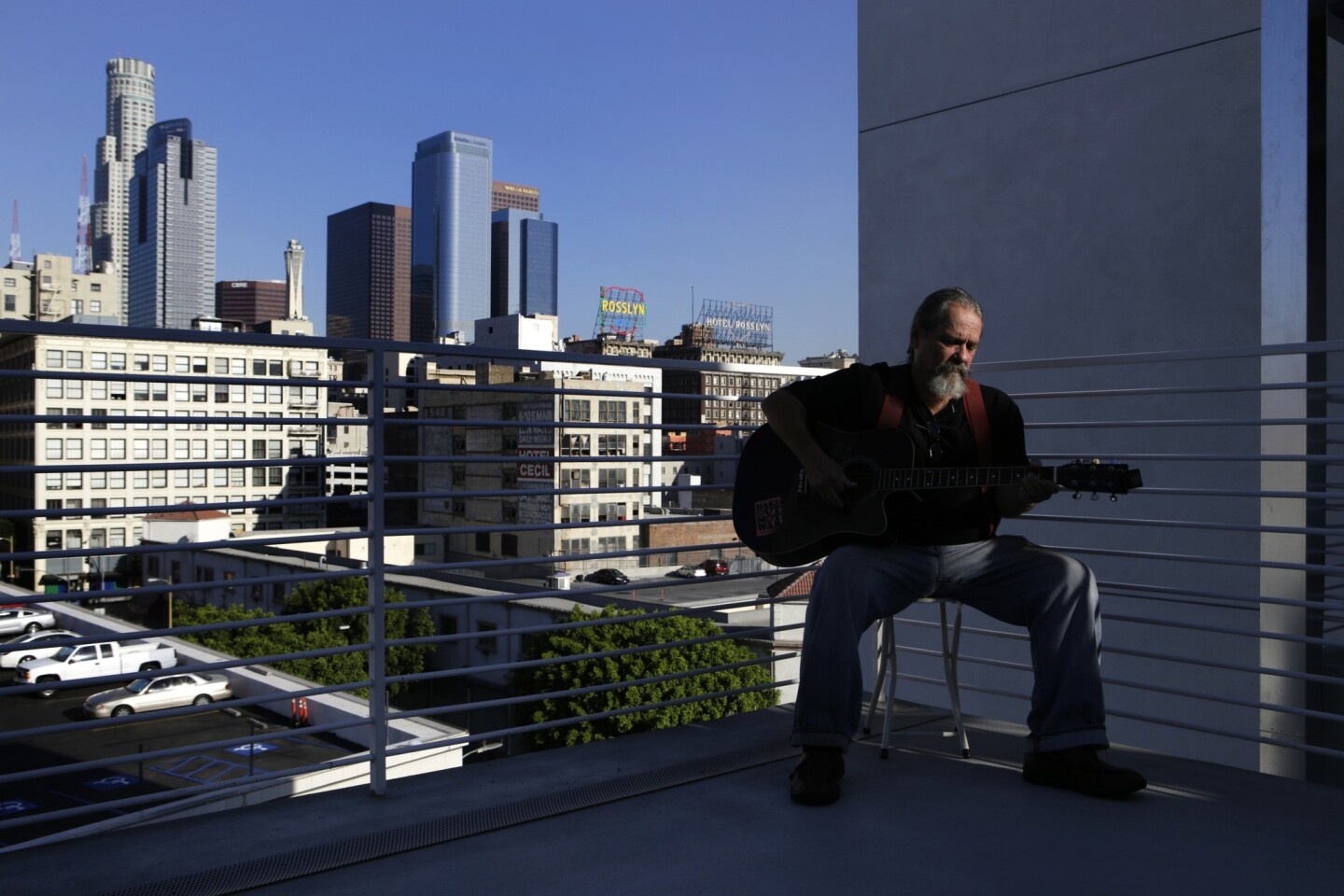 Bill Fisher, 61, has a view of the downtown L.A. skyline from outside his apartment in a new complex at 6th Street and Maple Avenue in skid row.