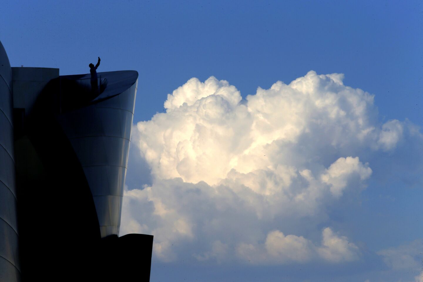 Cumulus clouds frame Disney Hall in downtown Los Angeles as scorching heat continues across the Southland.
