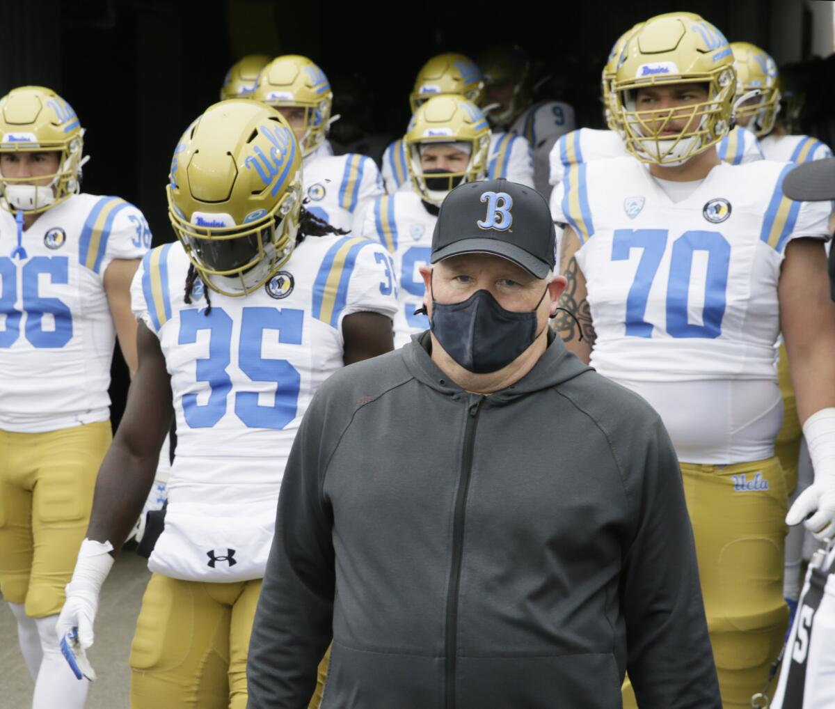 UCLA coach Chip Kelly leads his team on the field before its game against Oregon on Nov. 21, 2020, in Eugene, Ore.