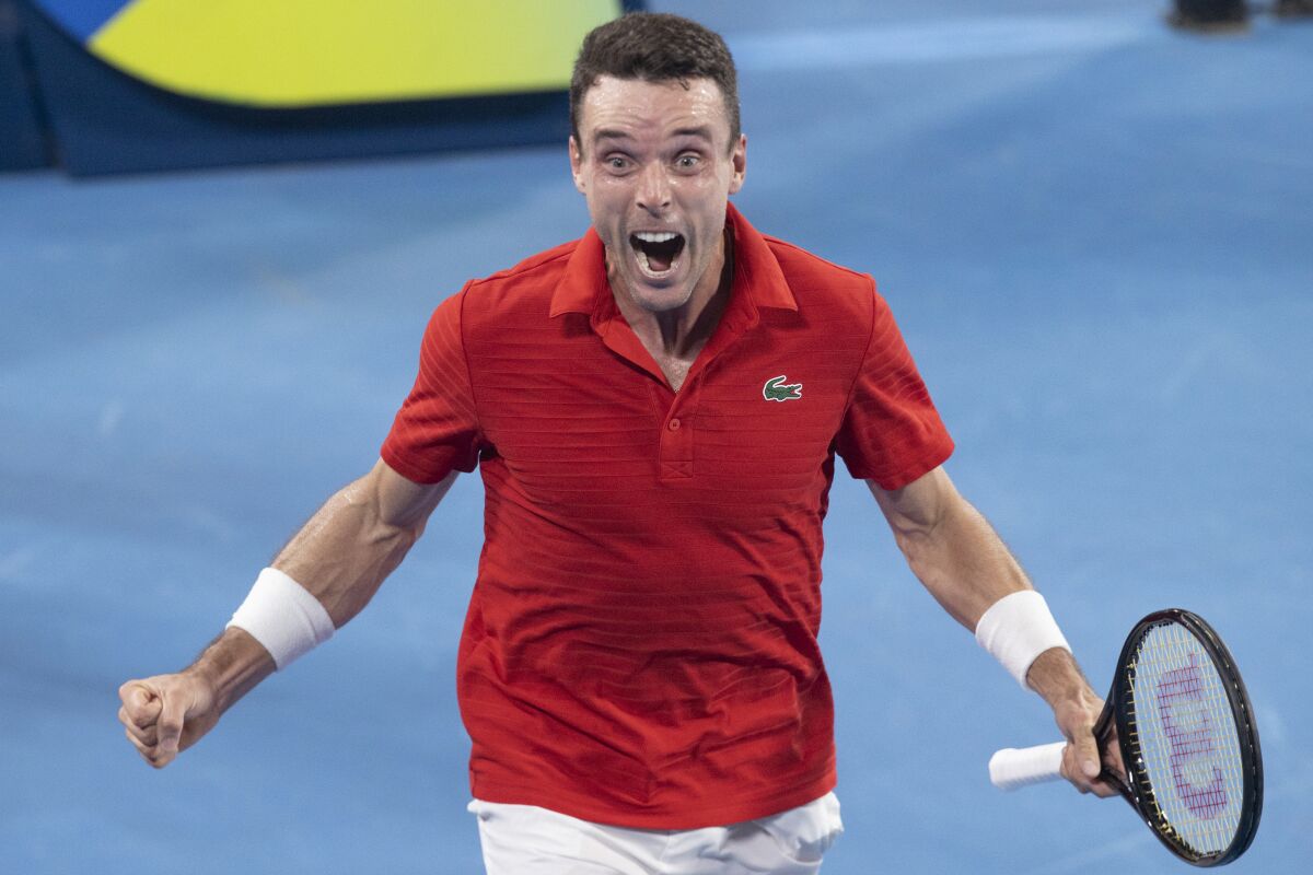 Roberto Bautista Agut of Spain reacts after defeating Poland's Hubert Hurkacz during their semifinal match at the ATP Cup tennis tournament in Sydney, Friday, Jan. 7, 2022. (AP Photo/Steve Christo)