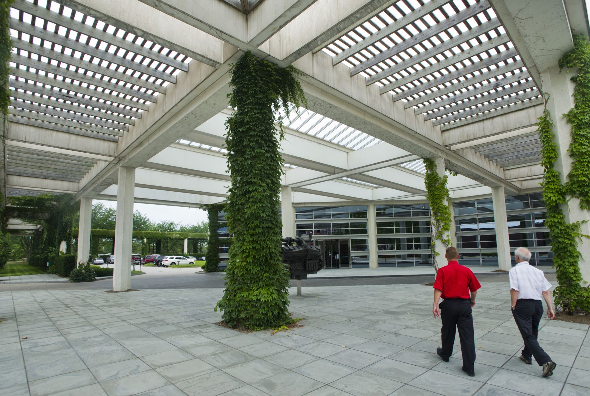People walk through a partially covered courtyard at the Cummins corporate offices in Columbus, Ind.