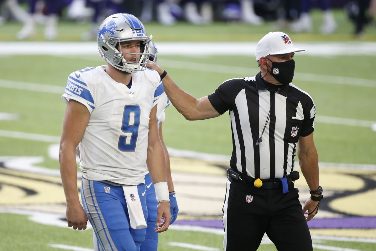 Detroit Lions quarterback Matthew Stafford (9) is helped off the field after getting injured during the second half of an NFL football game against the Minnesota Vikings, Sunday, Nov. 8, 2020, in Minneapolis. (AP Photo/Bruce Kluckhohn)