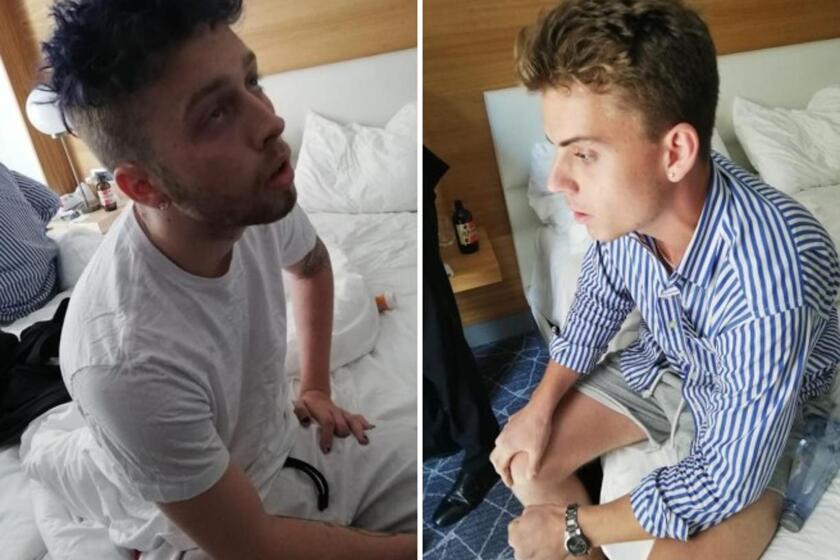 In a photo released by Italian Carabinieri, Finnegan Lee Elder, left, and Gabriel Christian Natale Hjorth sit in their hotel room in Rome.