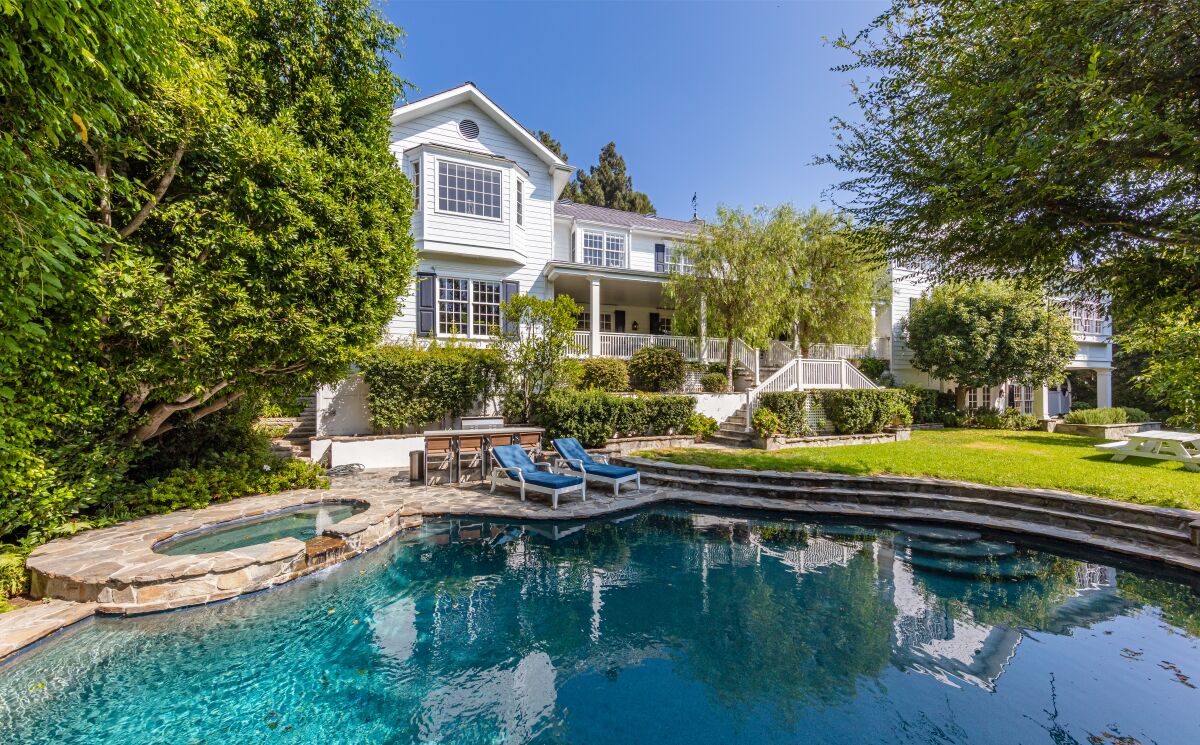 The 1990s home includes five bedrooms, 5.5 bathrooms, a mahogany office, bar, wine cellar, sauna and gym.