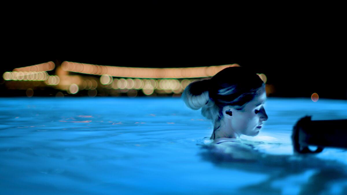 Paris Hilton reflects in a Mykonos pool in a scene from "This Is Paris."