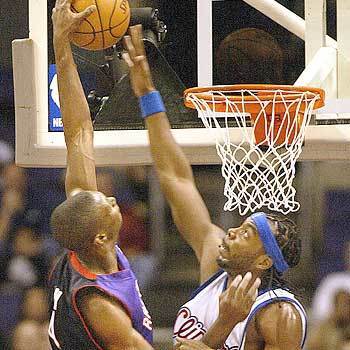Clippers' Chris Wilcox goes up to block the shot of Toronto's Chris Bosh in the first half during the game at Staples Center.