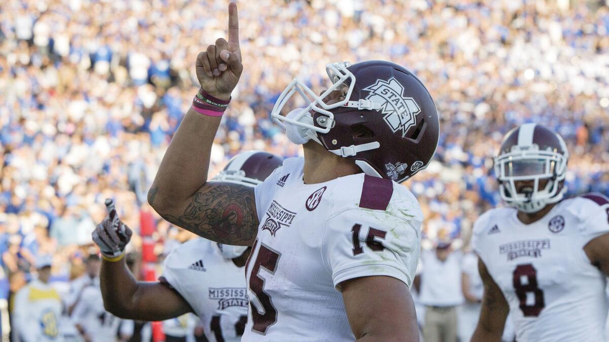 Mississippi State quarterback Dak Prescott celebrates after running for a touchdown against Kentucky on Saturday.
