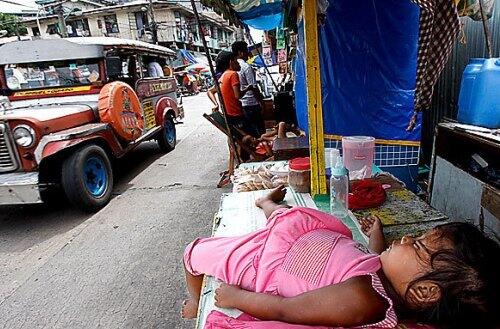A girl naps in a food stall