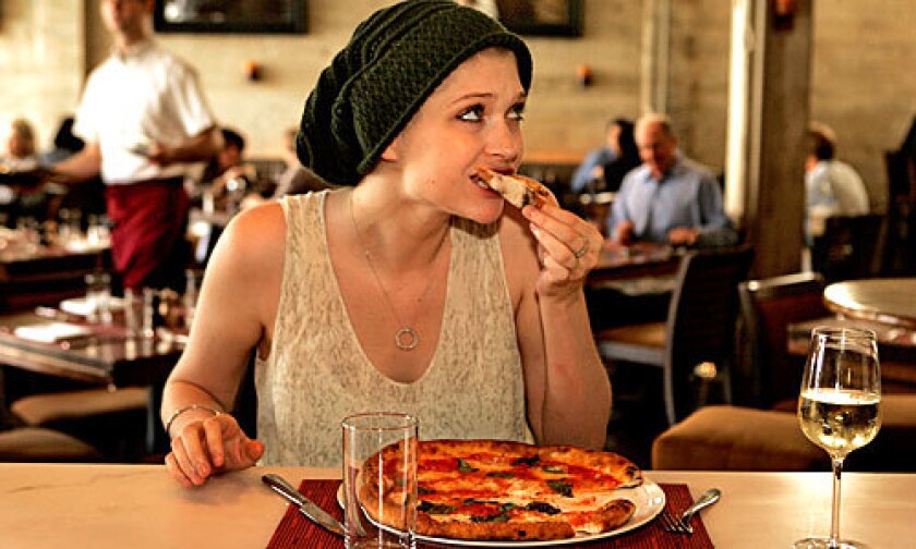 CLASSIC TASTE: Olivia Fox, 22, eats a Margherita pizza at Riva.