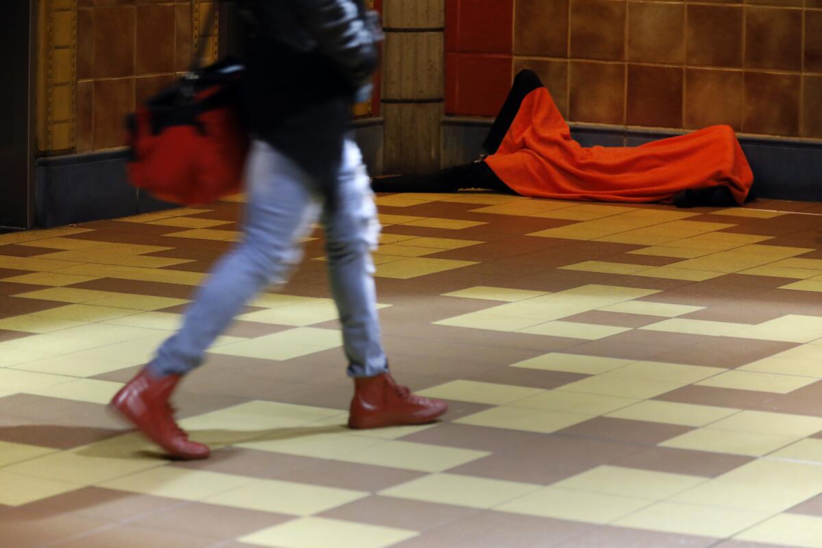 A homeless person sleeping in a Metro station