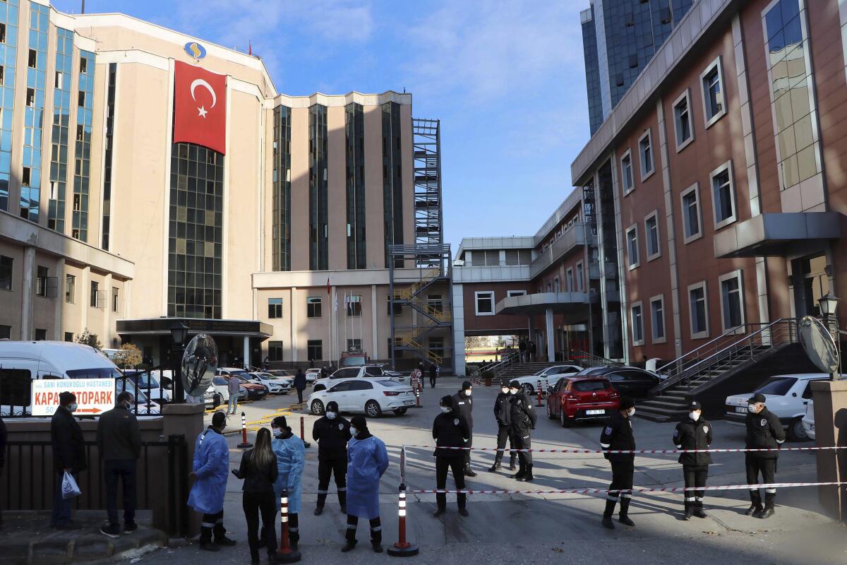 Police and medical personnel gather outside the Sanko University Hospital in Gaziantep, Turkey, after a fire Saturday.