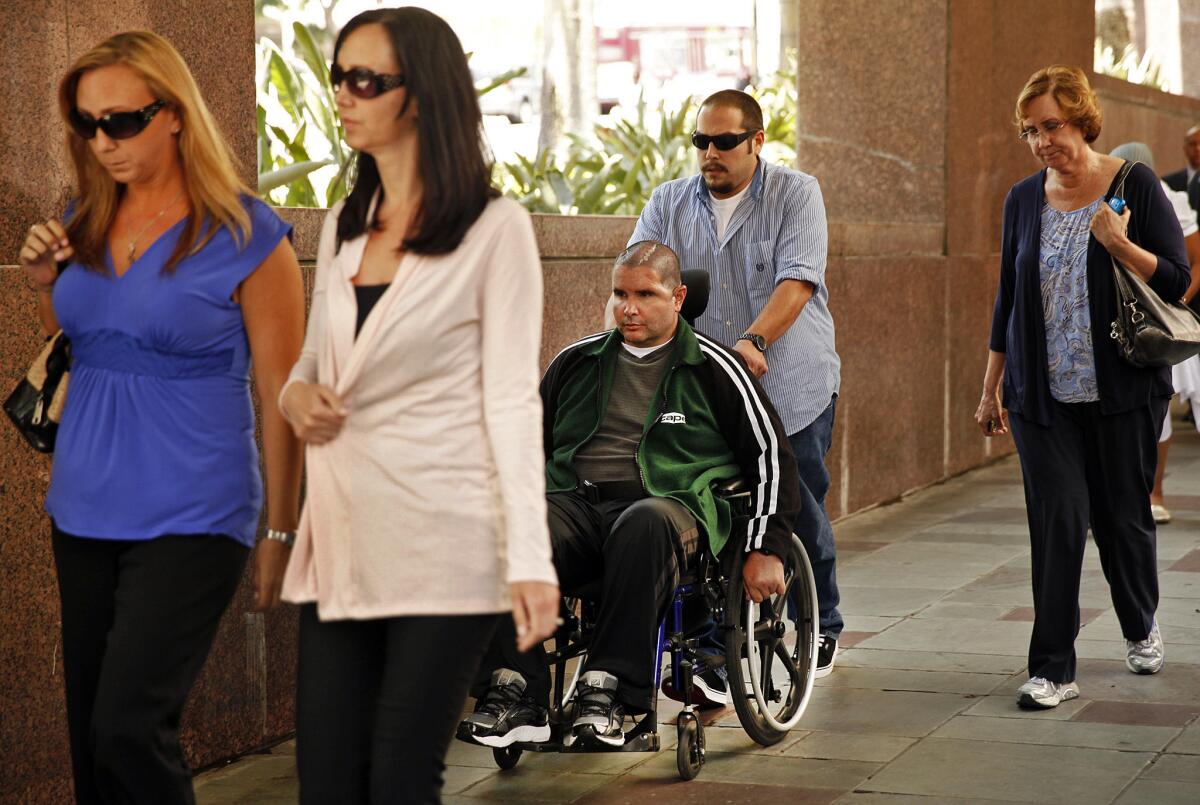 Bryan Stow leaves court in downtown Los Angeles with a caregiver Wednesday. With them are Stow's sisters Erin Collins, left, and Bonnie Stow, and his mother, Ann Stow, far right.