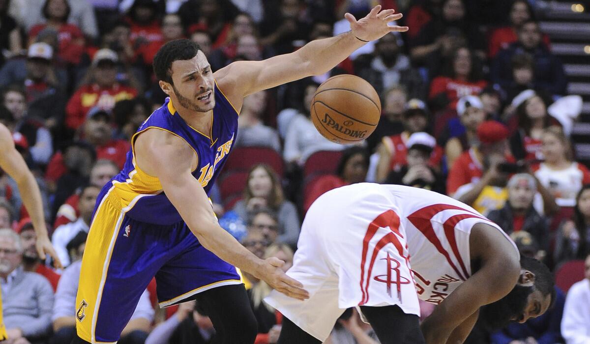 Lakers forward Larry Nance Jr., left, chases after a loose ball next to Houston Rockets guard James Harden in the first half Wednesday.