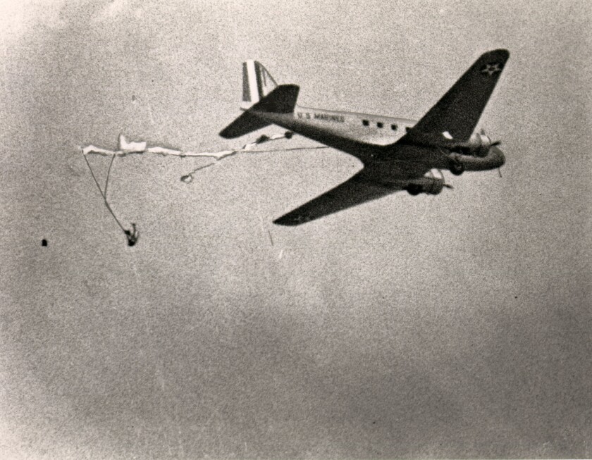 Lt. Walter S. Osipoff  is shown in this photo by Harry T. Bishop dangling from a parachute caught on a plane on May 15, 1941