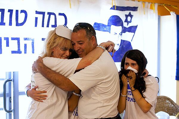 Israelis in Mitzpe Hila celebrate after seeing the first images of Gilad Shalit on TV after his release.