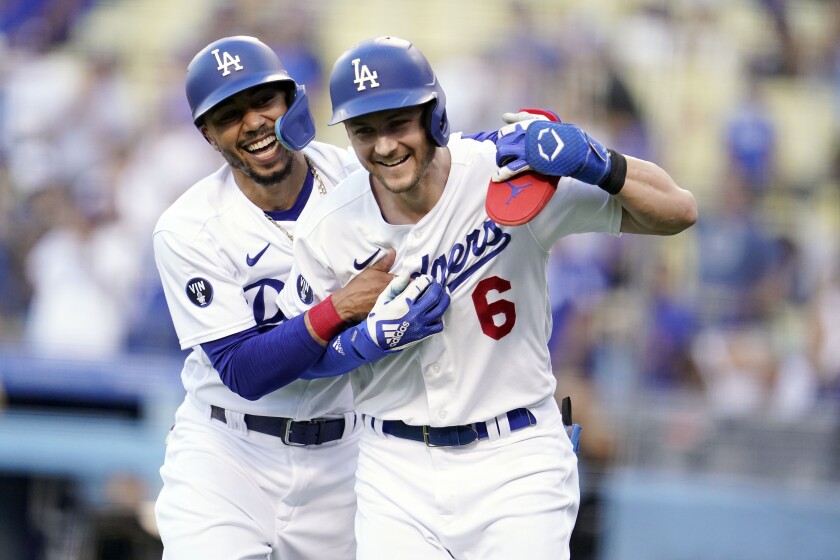 The Dodgers' Trea Turner, right, celebrates after hitting a double home run with Mookie Betts.