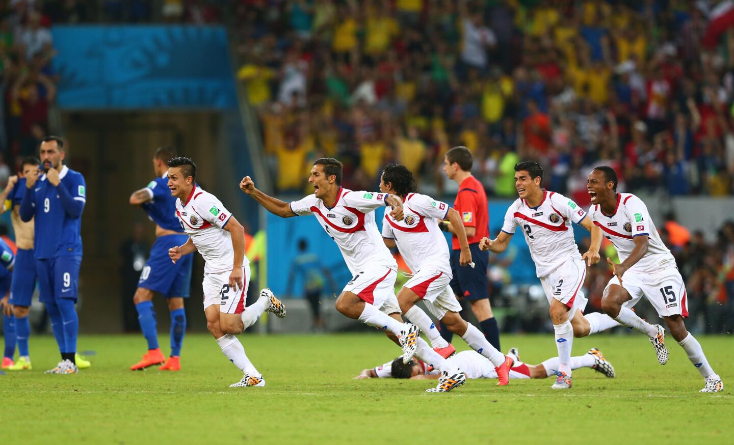 Costa Rica players celebrate after defeating Greece in a penalty shootout.