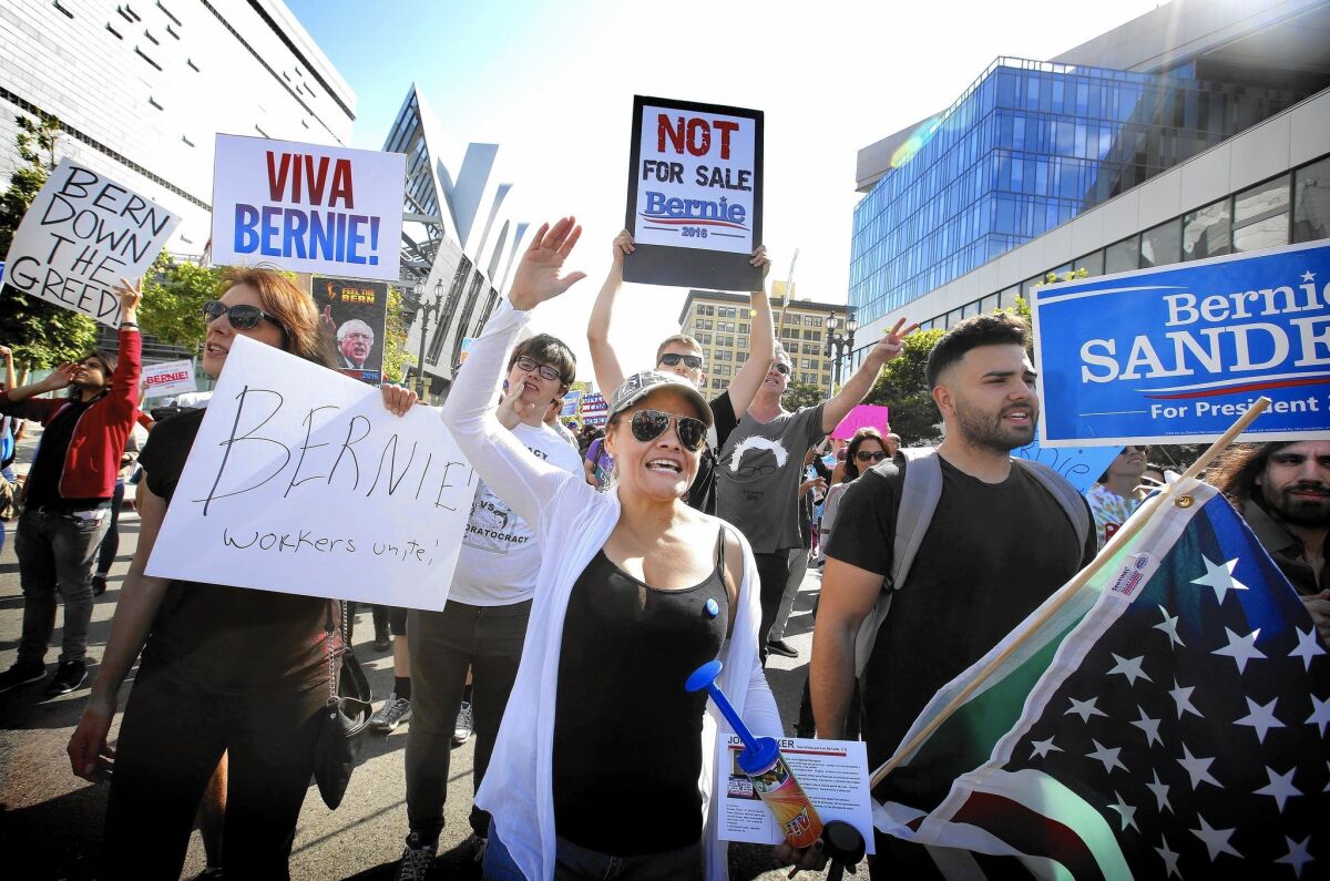 Sanders supporters march in downtown L.A. The campaign is already relying more on activism in California and less on media buys.
