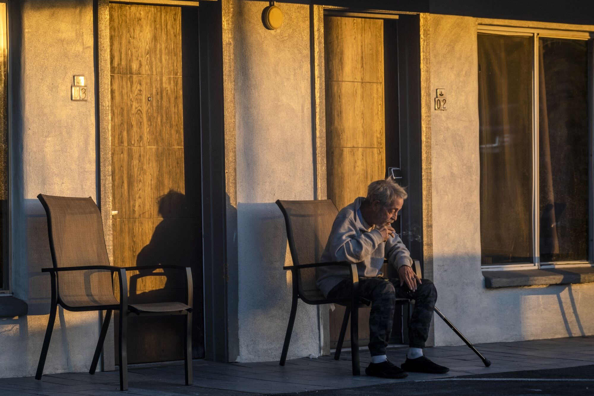 Joel Strauss, 62, outside his room smoking a cigarette at the Desert Moon Motel. 