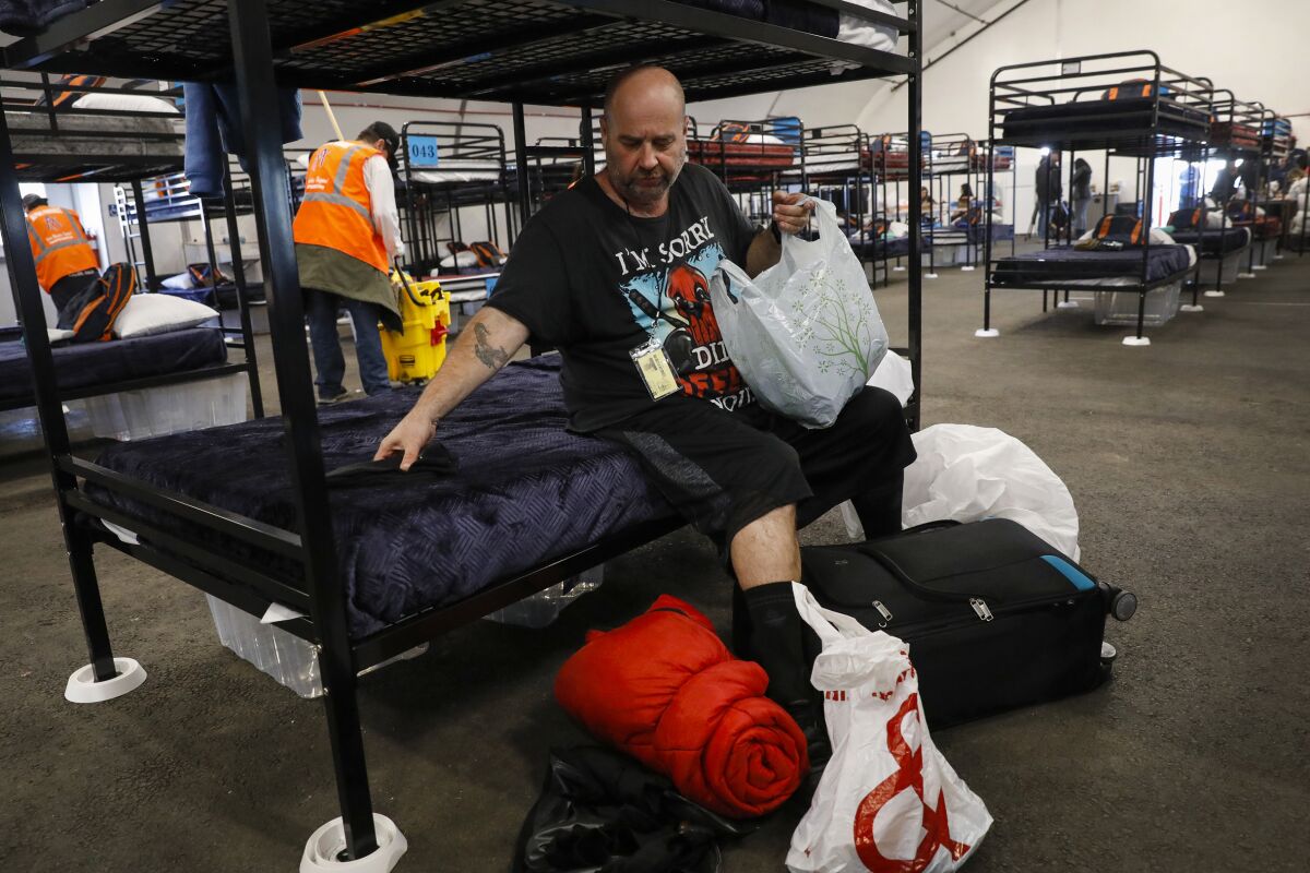 Carlos Fisher unpacks some of his belongings at a shelter in November.