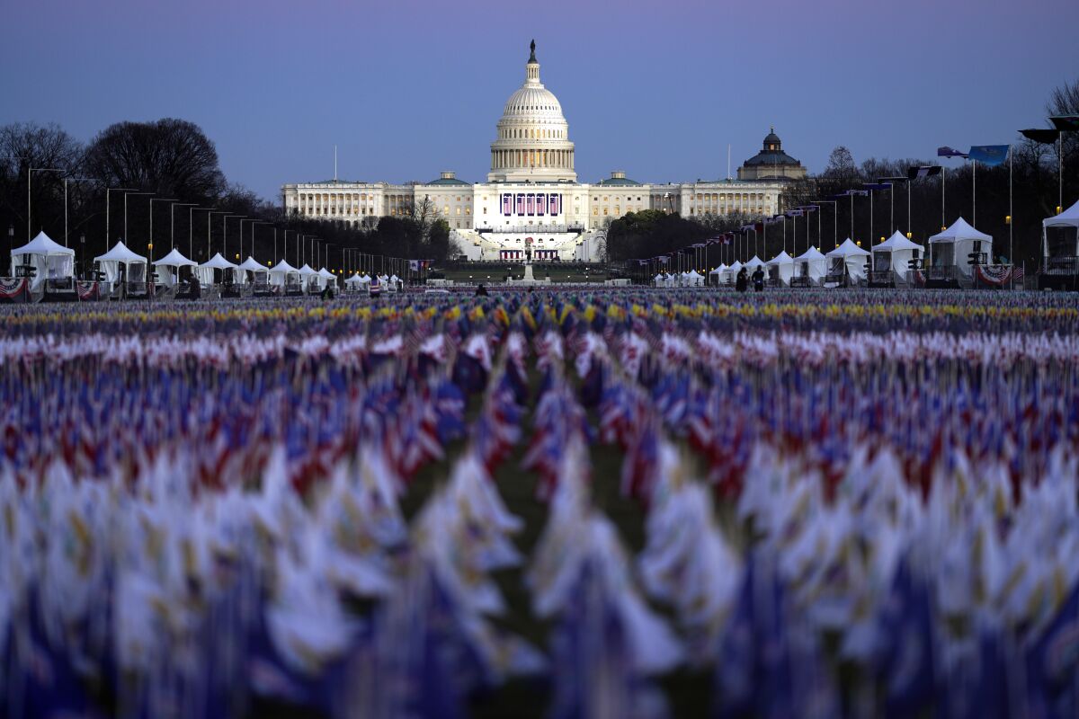 Rows of small flags line the National Mall with the U.S. Capitol building in the background