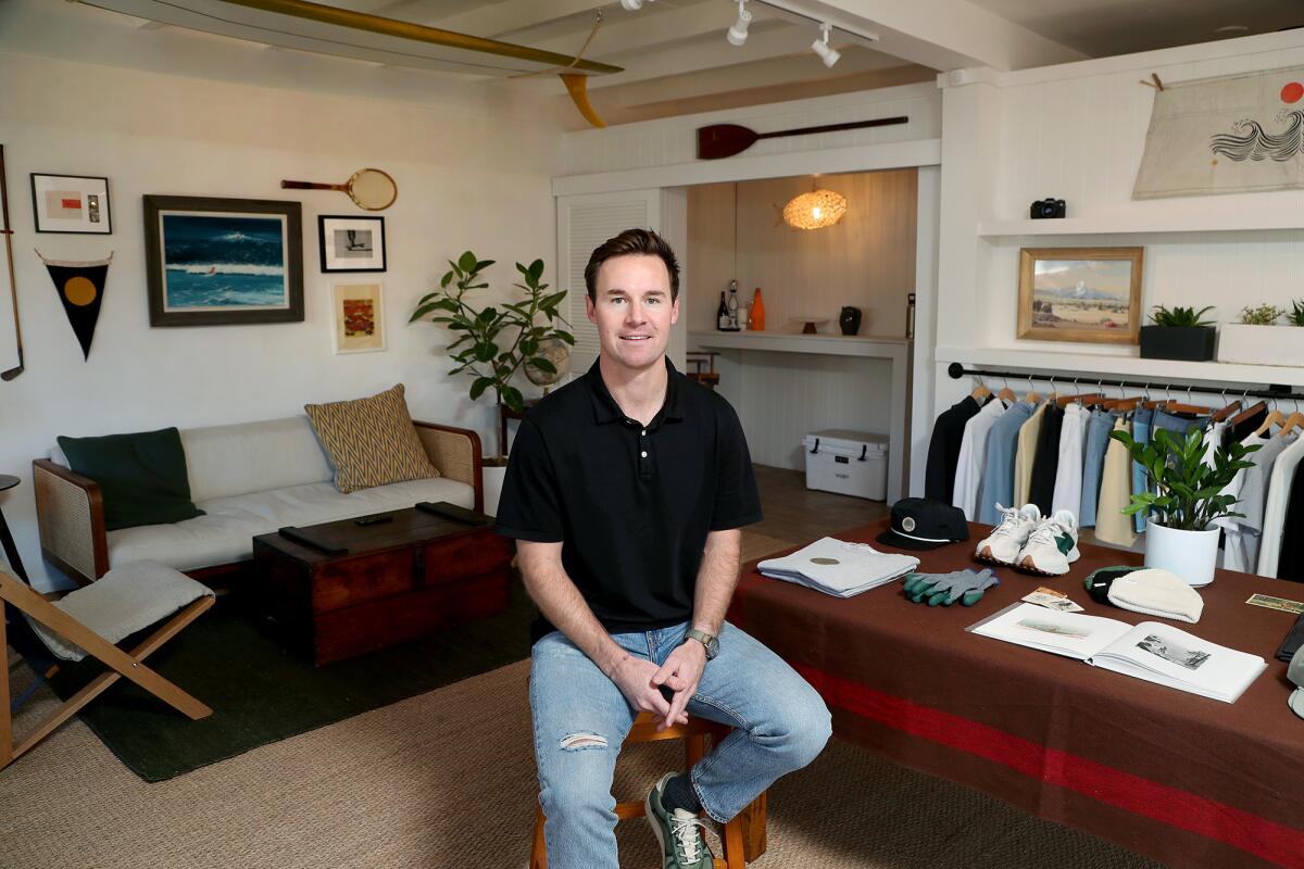 WILLBO founder Robbie McInerny, 27, seated inside his apparel store in Laguna Beach.