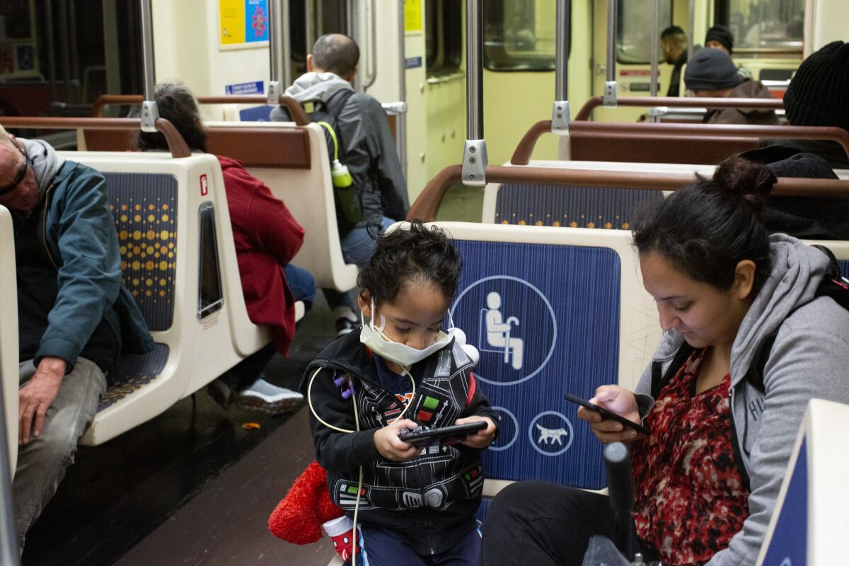 Commuters ride the The Los Angeles Metro Metro D Line. (Gabriella Angotti-Jones/Los Angeles Times)