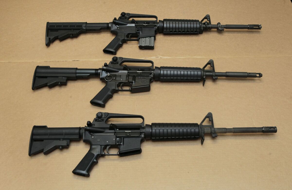 In this Aug. 15, 2012, file photo, three variations of the AR-15 assault rifle are displayed.
