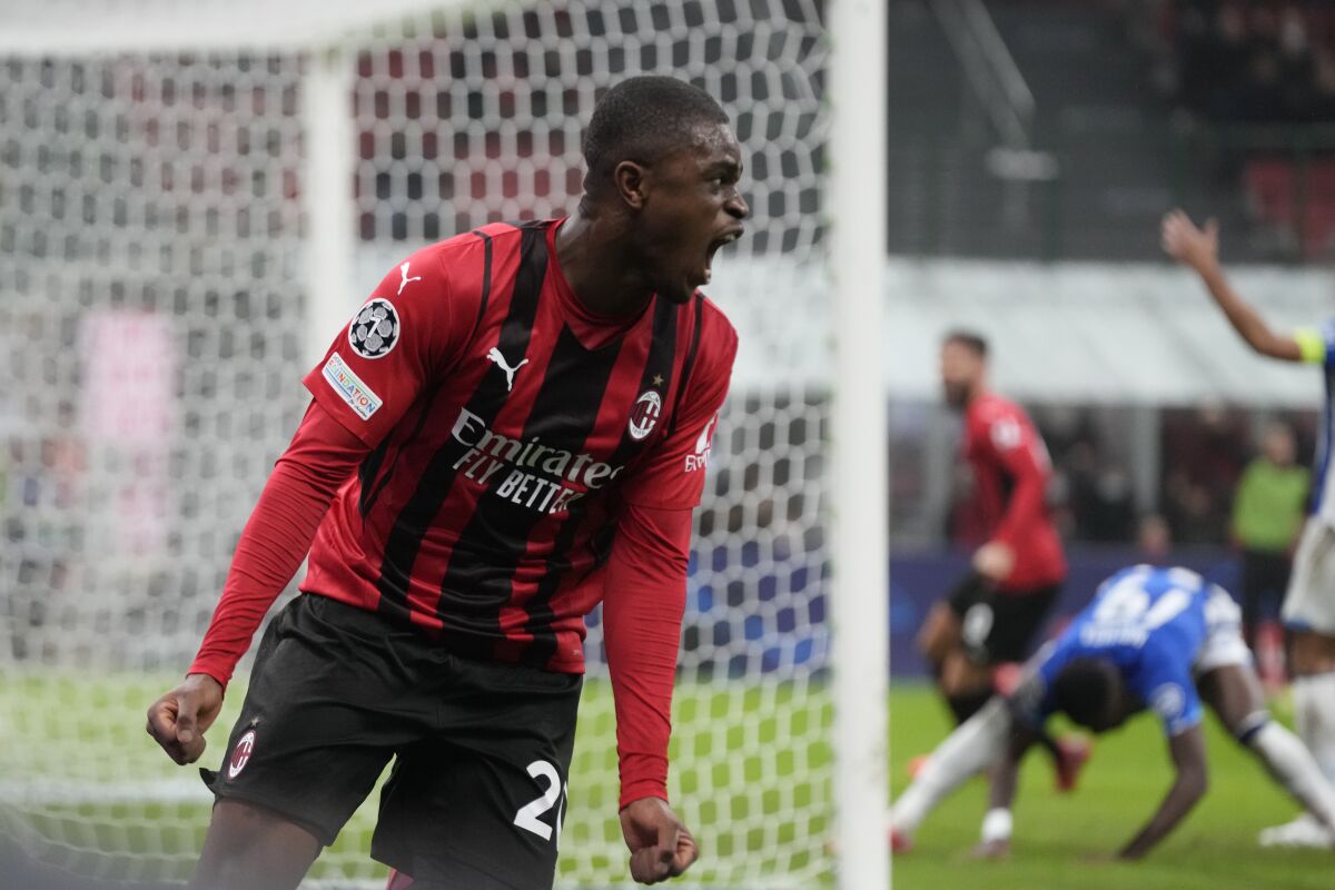 AC Milan's Pierre Kalulu, right, celebrates after scoring his side's opening goal during the Champions League group B soccer match between AC Milan and Porto at the San Siro stadium in Milan, Italy, Wednesday, Nov. 3, 2021. (AP Photo/Luca Bruno)